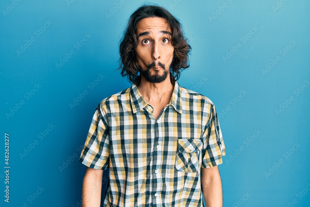Young hispanic man wearing casual clothes making fish face with lips, crazy and comical gesture. funny expression. Young hispanic man wearing casual clothes making fish face with lips, crazy and comical gesture. funny expression.
