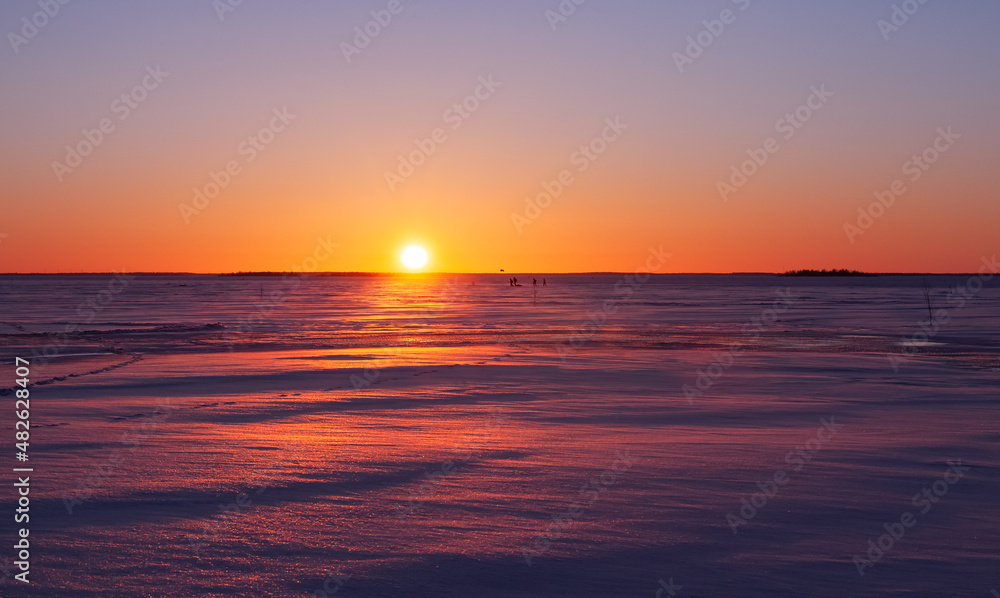 Winter landscape. Sunset over the frozen sea.
