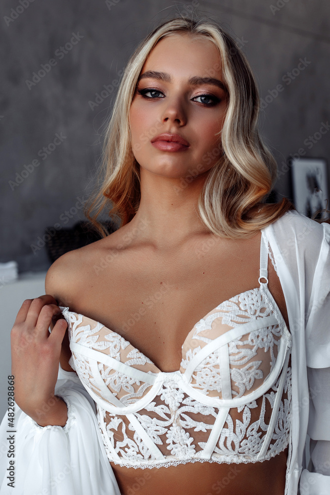 Blonde portrait. Demonstration of women's white underwear. Bride morning. Blonde portrait. Demonstration of women's white underwear. Bride morning.