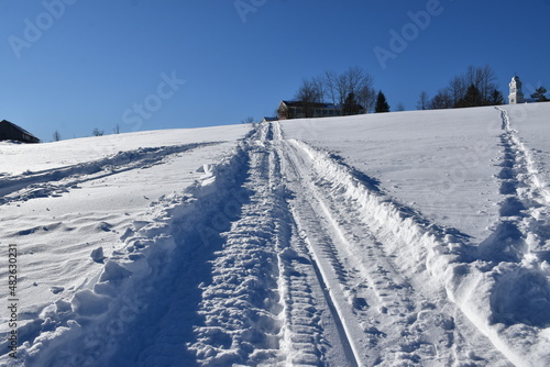 A snowmobile trail under a blue sky  Sainte-Apolline  Qu  bec  Canada