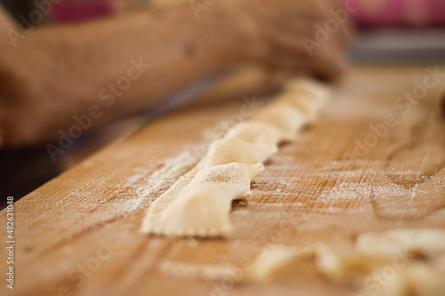 Fresh italian ravioli pasta on wood background