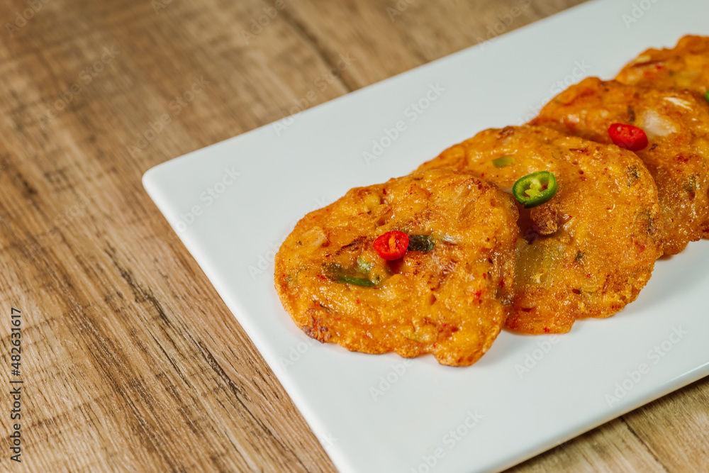 kimchijeon, Korean food kimchi pancake : Slices of well-fermented kimchi mixed into a flour batter and pan- fried. Finely chopped pork, squid, and clam meat may be added to the batter as well. kimchijeon, Korean food kimchi pancake : Slices of well-fermented kimchi mixed into a flour batter and pan- fried. Finely chopped pork, squid, and clam meat may be added to the batter as well.