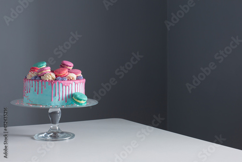 blue and pink cake on backgound dark wall