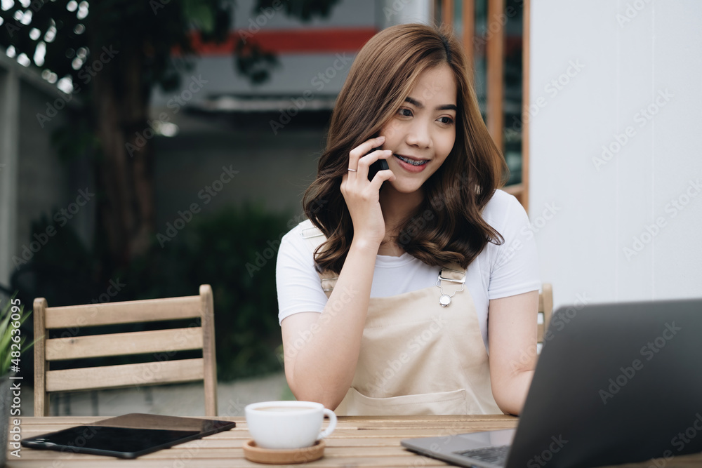 Young Asian student talking with friend by mobile phone outdoor park. Young Asian student talking with friend by mobile phone outdoor park.
