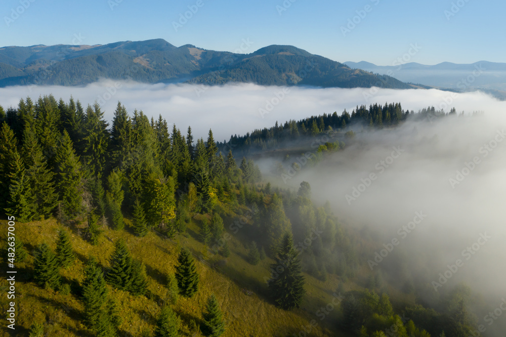 Aerial view of beautiful landscape with misty forest in mountains Aerial view of beautiful landscape with misty forest in mountains
