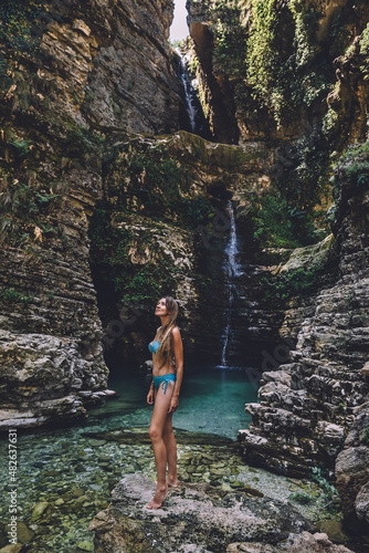 Woman in Swimsuit Enjoying Wild Waterfalls