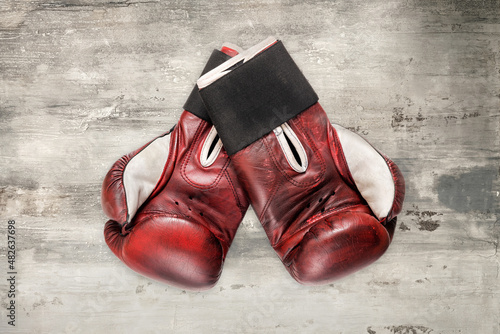 Pair of vintage boxing gloves on grunge grey background