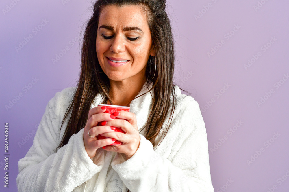 Beautiful Smiling brunette Woman in white bathrobe waking up ,stretching and smiling Beautiful Smiling brunette Woman in white bathrobe waking up ,stretching and smiling