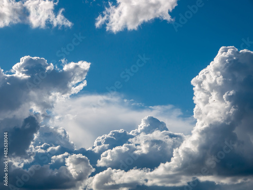 White fluffy epic clouds on blue sky