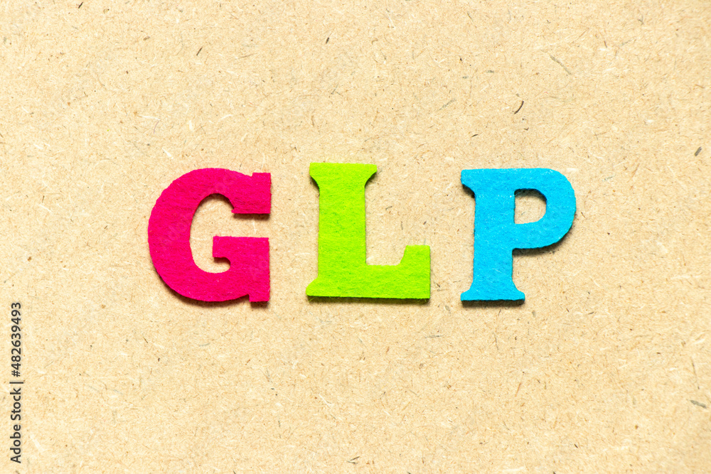 Color cloth alphabet letter in word GLP (Abbreviation of Good laboratory practice) on wood background
