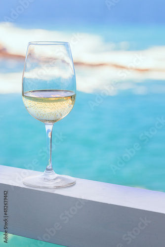 White wine glass on the hotel balcony with tropiucal sea view in exotic country