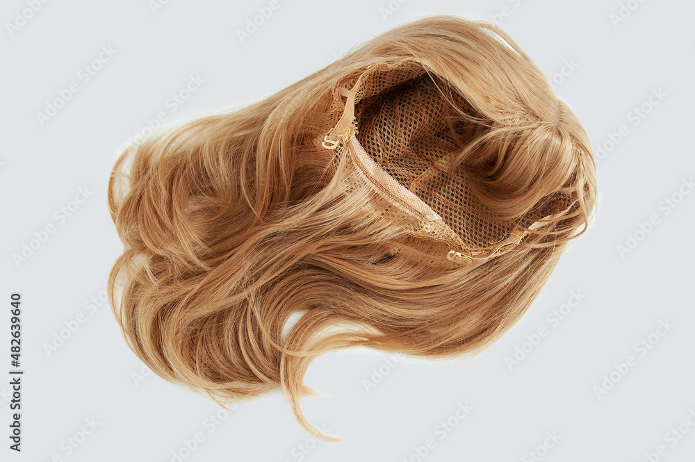 Women wig with bangs on  grid with fasteners blond. White background.