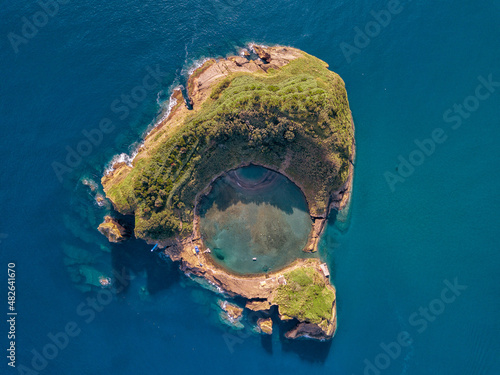 Azores aerial panoramic view. Top view of Islet of Vila Franca do Campo. Crater of an old underwater volcano. Sao Miguel island, Azores, Portugal. Heart carved by nature. Bird eye view. photo