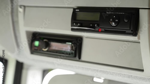 Driver ejects drivers card out of a digital tachograph photo