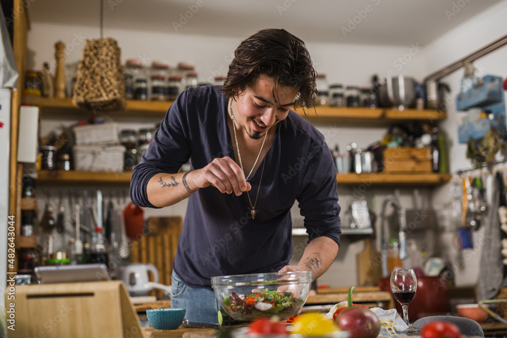 young man preparing food in kitchen