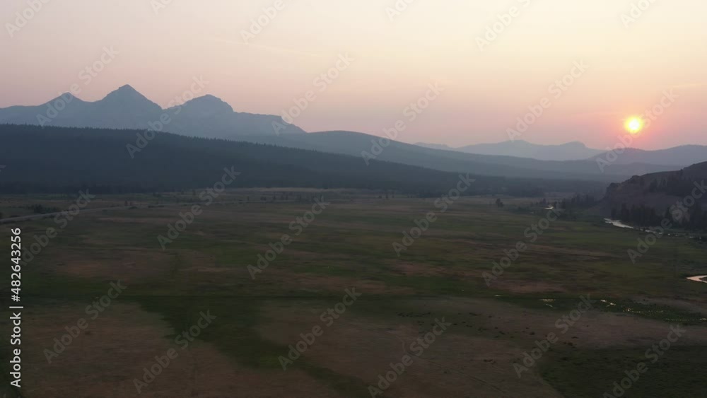 An aerial shot of Valley Creek in Stanley, Idaho at sunset during a summer evening. The camera tracks from left to right. An aerial shot of Valley Creek in Stanley, Idaho at sunset during a summer evening. The camera tracks from left to right.