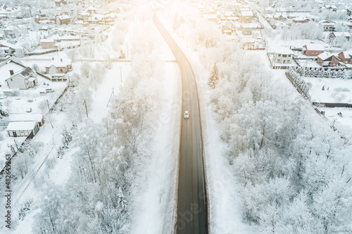 Aerial view of snow winter road with car on sunrise © nblxer