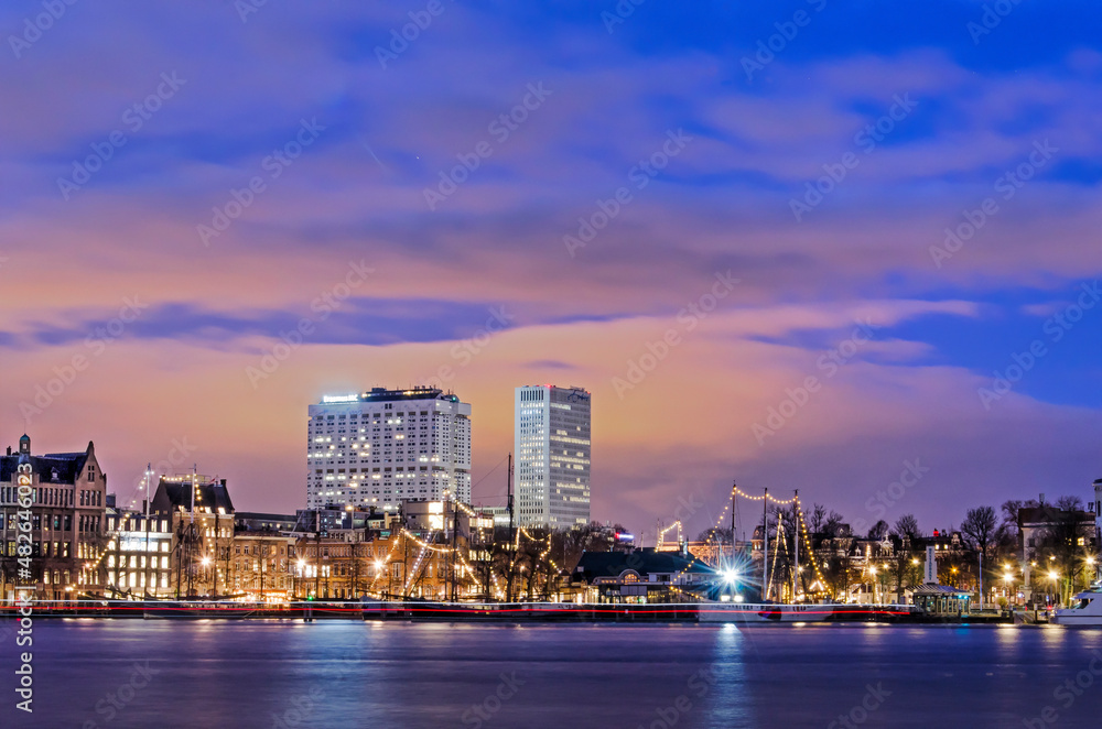 Rotterdam, The Netherlands, January 20, 2022: view across the river Nieuwe Maas in the blue hour towards Veerhaven marina and Erasmus MC hospital