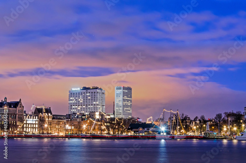 Rotterdam, The Netherlands, January 20, 2022: view across the river Nieuwe Maas in the blue hour towards Veerhaven marina and Erasmus MC hospital © Frans