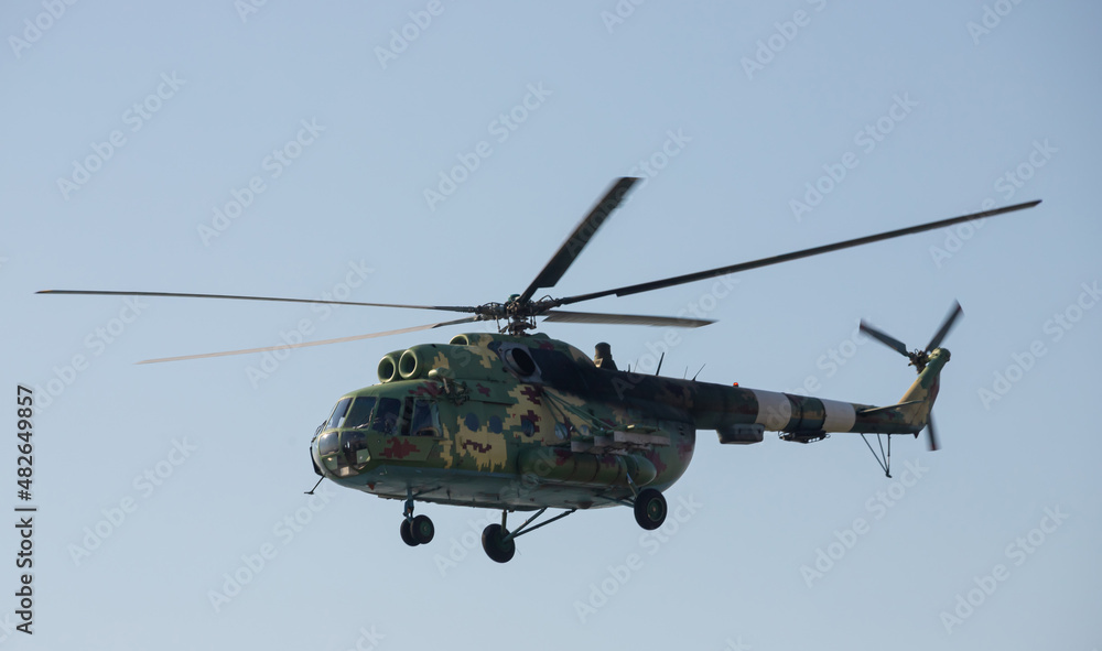 Fototapeta premium The military helicopter against the blue sky