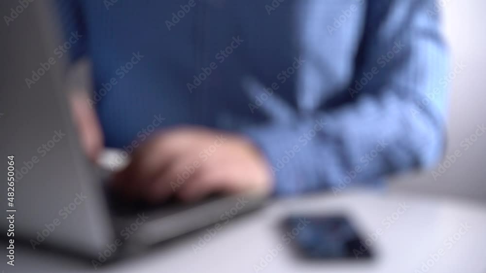 Work in a Light Modern Office. Young Modern Man Working on Laptop. Blurred Video. Work in a Light Modern Office. Young Modern Man Working on Laptop. Blurred Video.