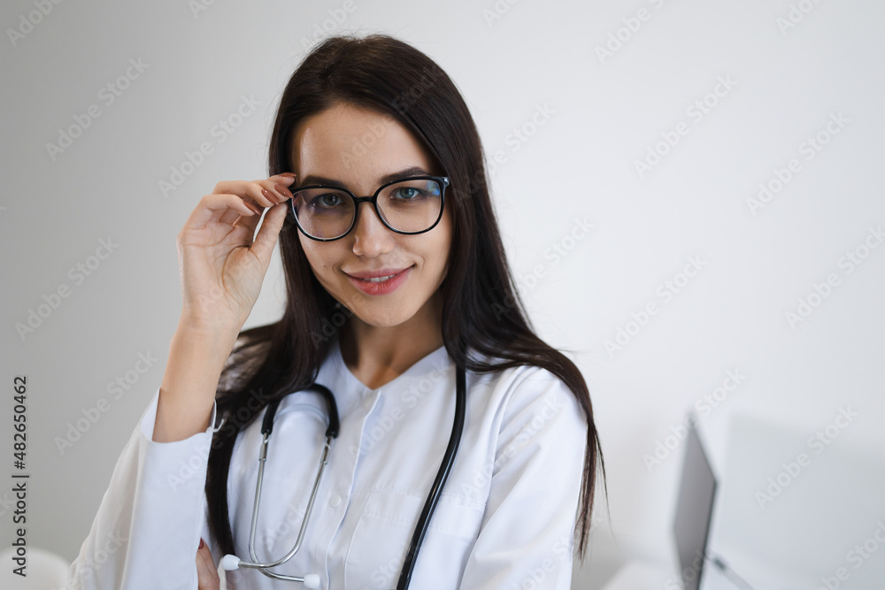 Beautiful young nurse in eyeglasses. Female doctor portrait Beautiful young nurse in eyeglasses. Female doctor portrait
