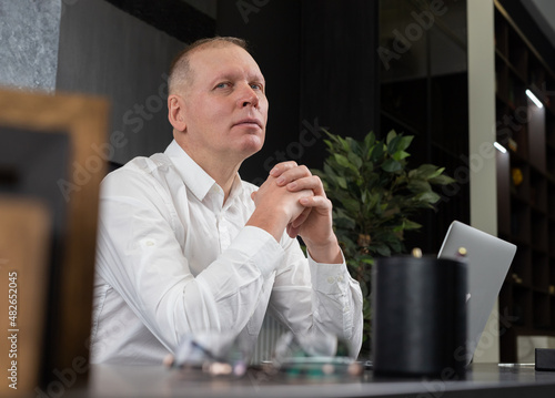 Mature busineesman at office table portrait. Business man at desk photo