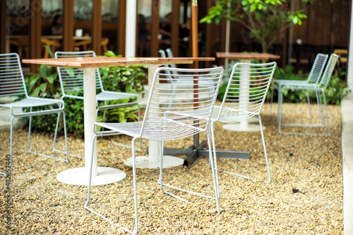 Closeup group of modern metal chaires and table in white color at the outdoor cafe photo