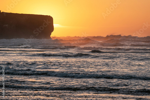Waves at sunset in Amoreira Beach. Aljezur. Algarve