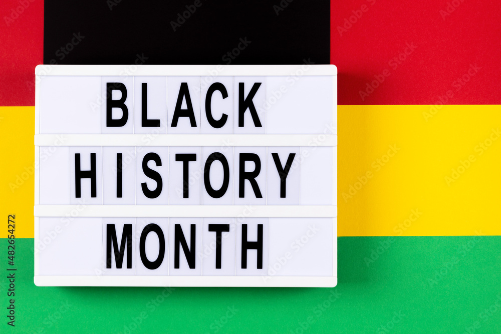 Lightbox with text Black History Month on red, yellow, green, black color background. Top view Lightbox with text Black History Month on red, yellow, green, black color background. Top view