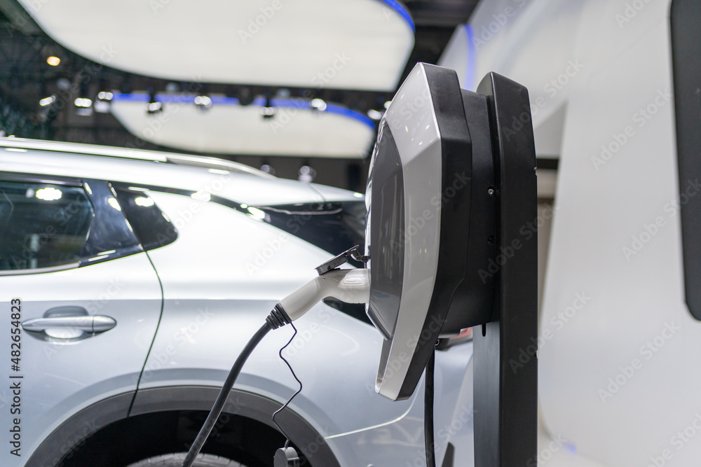 Electric car is charging in station