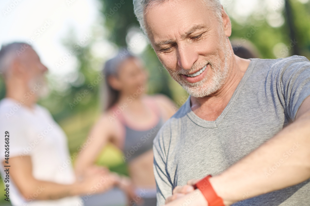 Group of people in sportswear before a morning workout in the park