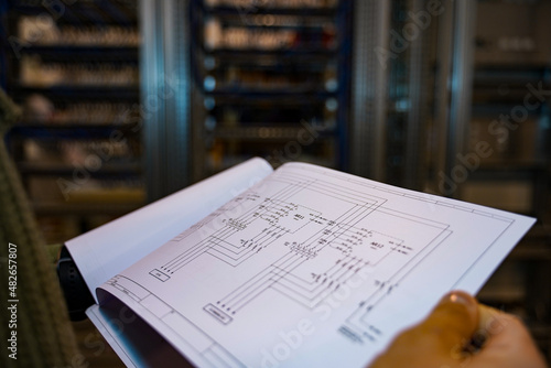 Engineer reviewing electrical plans of an industrial facility.