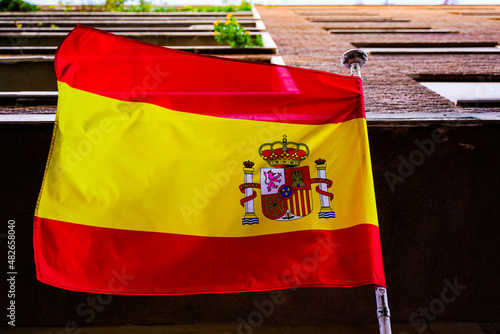 Red and yellow flag of the country of Spain waving in the wind.
