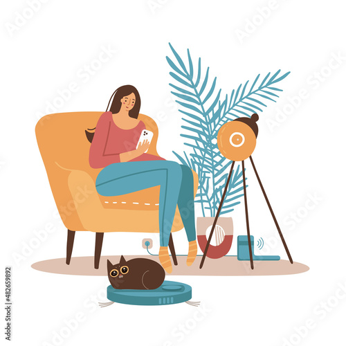 Woman controls a smart vacuum cleaner using a smartphone, lying on a comfortable sofa. Cat plays with a vacuum cleaner, rides a moving household appliances. Flat hand drawn vector illustration.