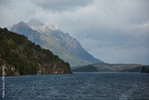Lake of the Argentinean Patagonia between mountains of the Andes Mountains. Chain of mountains and lakes of melting ice and glaciers with cloudy skies.