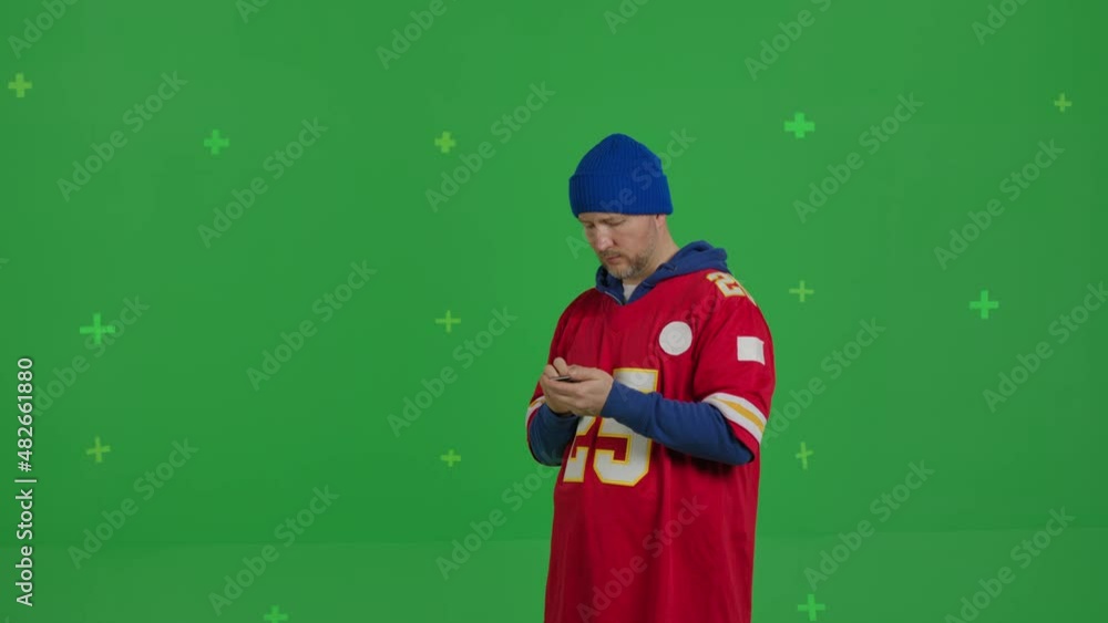 Handsome young man using his smartphone and looking at camera on a Green Screen, Chroma Key. Handsome young man using his smartphone and looking at camera on a Green Screen, Chroma Key.