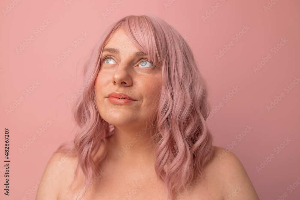 Portrait of pretty sexy girl with pink curly hair in lingerie posing isolated on pink background Portrait of pretty sexy girl with pink curly hair in lingerie posing isolated on pink background
