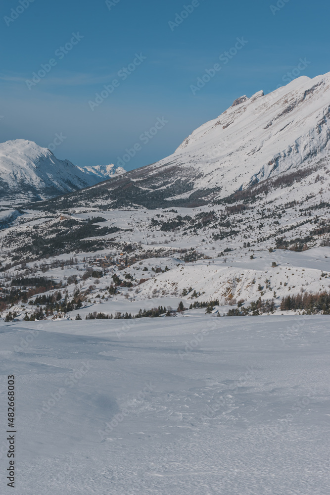 A picturesque vertical landscape view of the French Alps mountains on a cold winter day (Hautes-Alpes, Devoluy valley)
