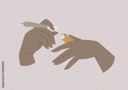 An isolated image of hands holding a lit cannabis joint and a lighter, recreational drugs, CBD hemp