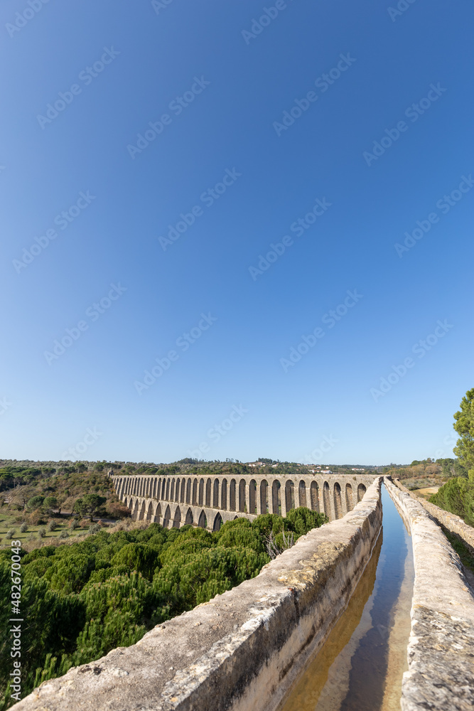 Tomar Aqueduct or Aqueduto de Pegoes, ancient stone masonry building, amazing monument. It was built in the 17th century to bring water to the convent of Christ in Tomar under command of king Philip I Tomar Aqueduct or Aqueduto de Pegoes, ancient stone masonry building, amazing monument. It was built in the 17th century to bring water to the convent of Christ in Tomar under command of king Philip I