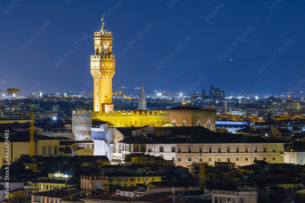 Arnolfo Tower of Palazzo Vecchio on Signoria square. Italian renaissance. Night Shot from Michelangelo square. Florence, Tuscany - 12 Jan 2022