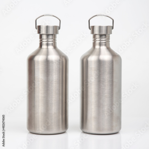 metal steel water flasks on white background. metal drinking utensils