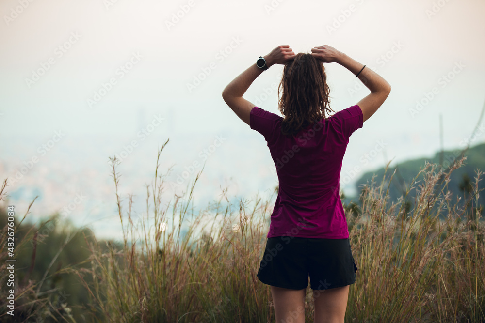 Girl doing stretching before running session outdoors Girl doing stretching before running session outdoors
