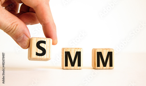 SMM, social media marketing symbol. Concept word SMM social media marketing on wooden cubes on beautiful white background, copy space. Business, SMM social media marketing concept.