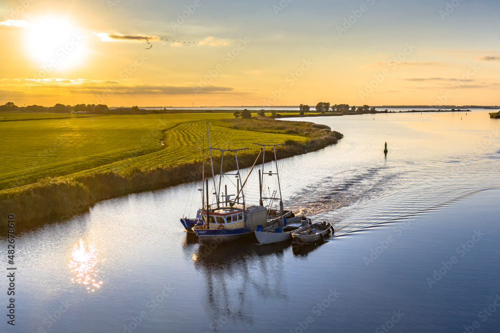 Aerial view of river with ship at sunset