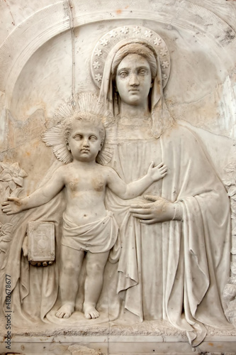 Closeup to Madonna with child traditional religious bas relief © havoc