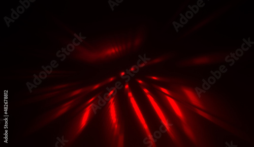 Light particles in motion, creating a burst of glowing multicolored rays on a black background. Energetic glow lights wallpaper.