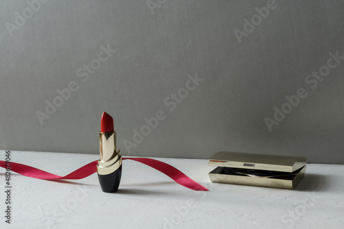Red lipstick on a light background. copy space.