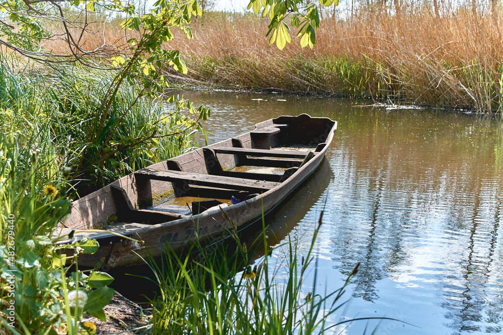 old wooden boat ,  boat moored on the river ,